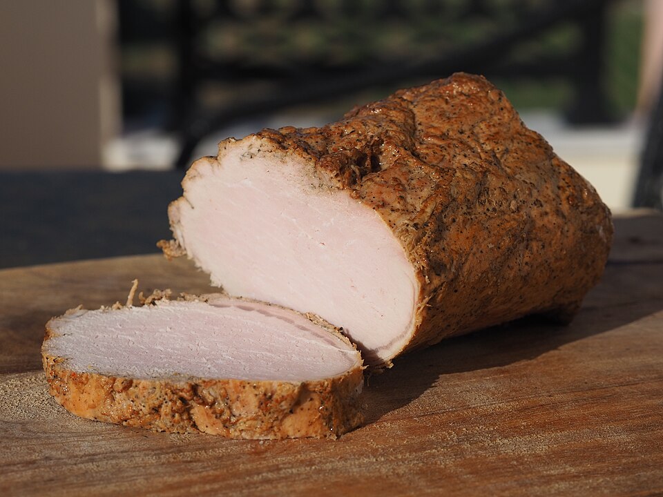 Sliced Cretan apaki smoked pork, pan-fried and served with lemon