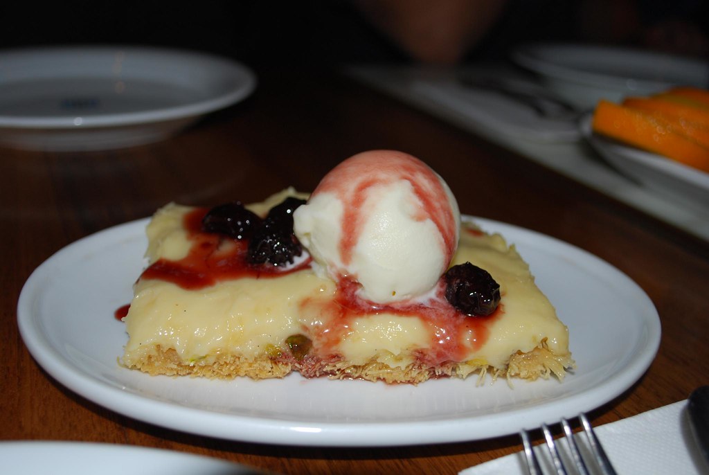A dish of Greek ekmek kataifi with custard and whipped cream