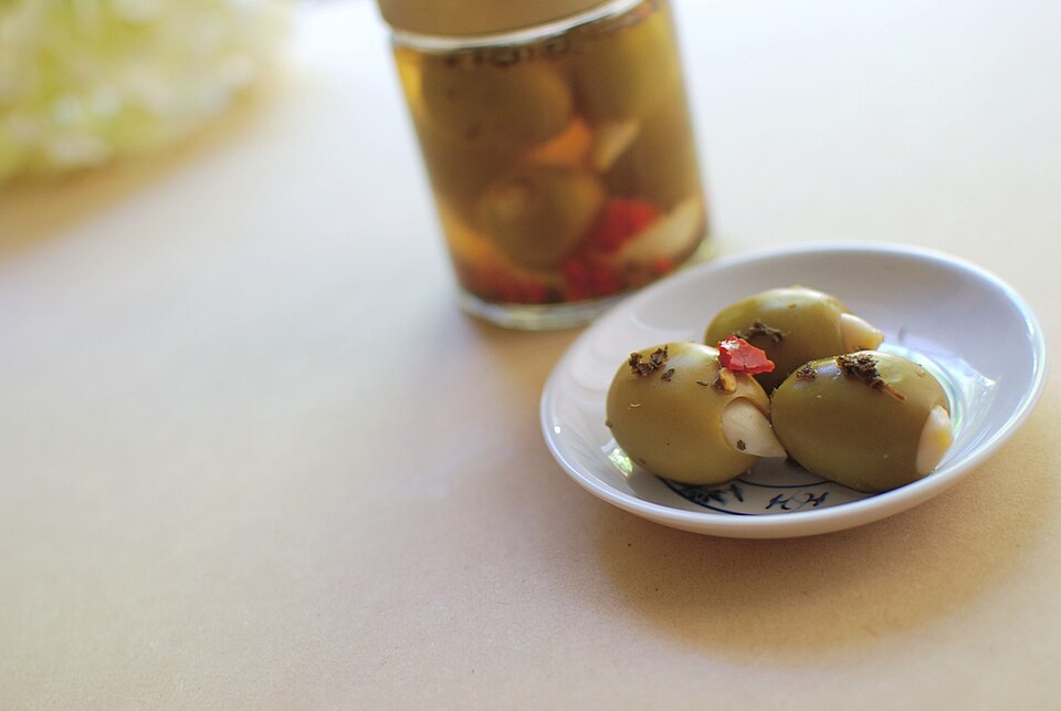 A bowl of Cretan elies tsakistes cracked green olives with garlic and coriander