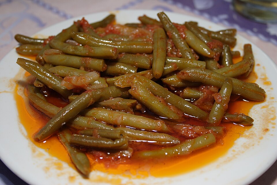 A pot of Greek fasolakia lathera green beans in tomato sauce