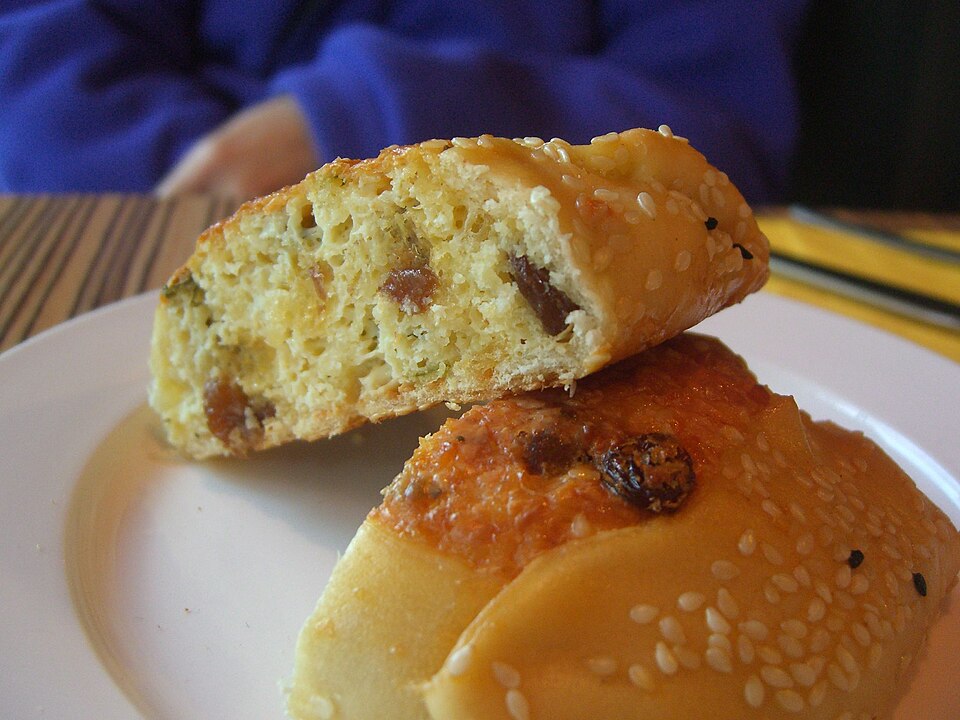 Cypriot flaounes cheese pastries with a golden sesame-topped crust