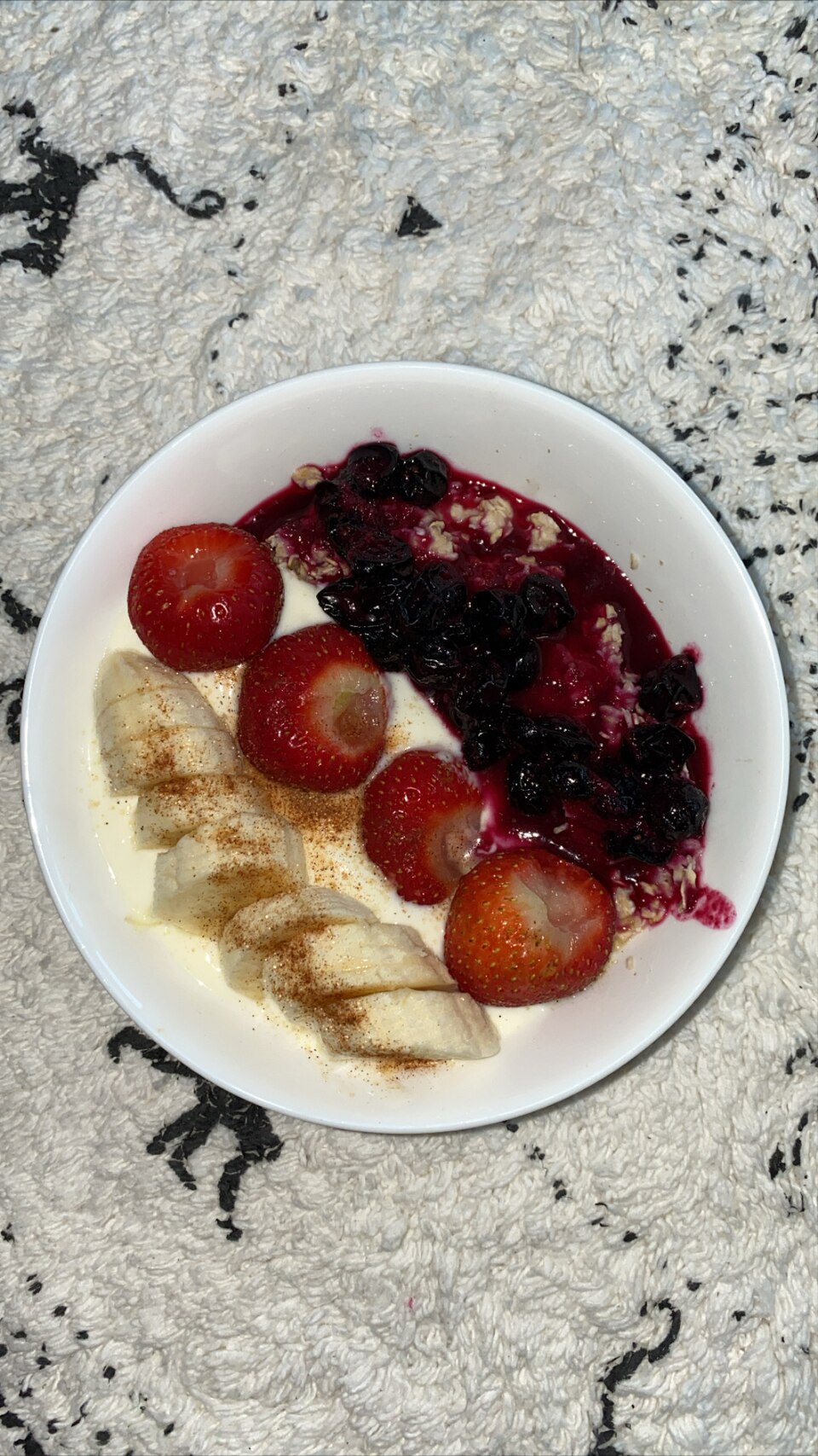 A bowl of Greek strained yogurt topped with fresh seasonal fruit