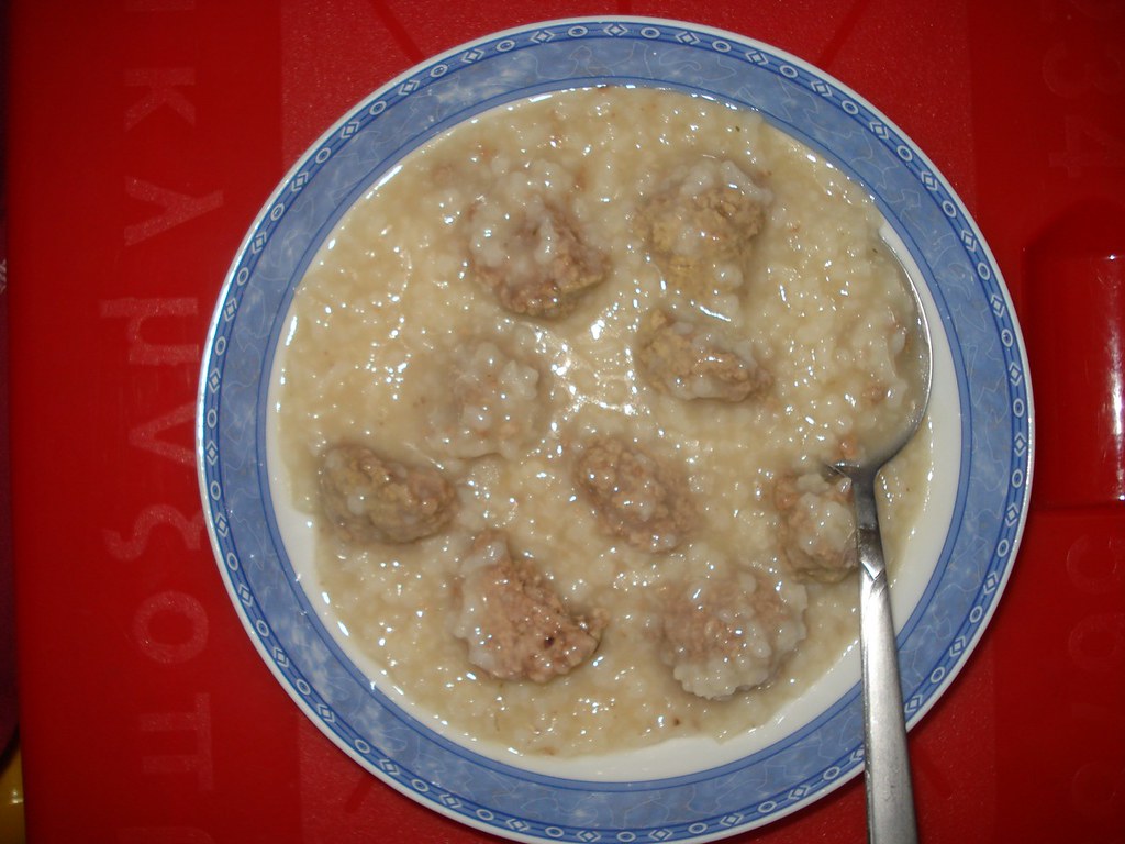 A bowl of Greek giouvarlakia meatball soup in avgolemono sauce
