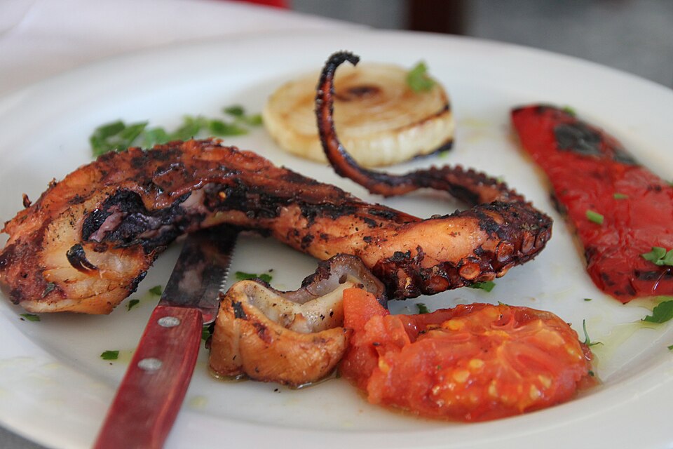 Charred grilled octopus tentacles dressed with olive oil, vinegar and oregano