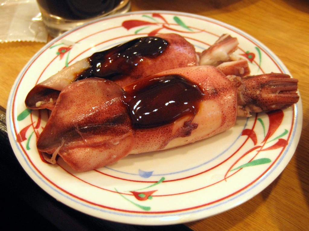 A dish of Greek kalamari gemisto stuffed squid in tomato sauce