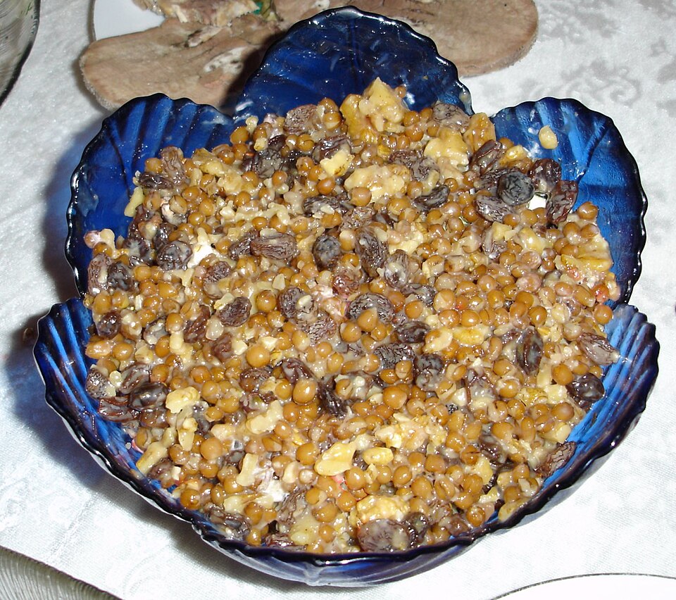 A tray of Greek kollyva memorial wheat decorated with pomegranate and nuts