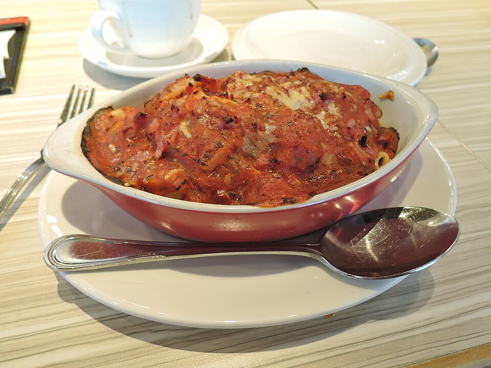 A dish of Greek kotopoulo giouvetsi chicken and orzo in tomato sauce