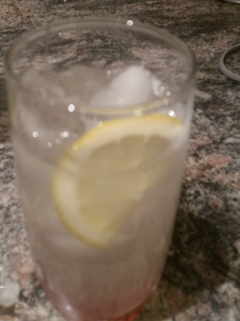 A glass of Greek limonada fresh lemonade with ice and mint