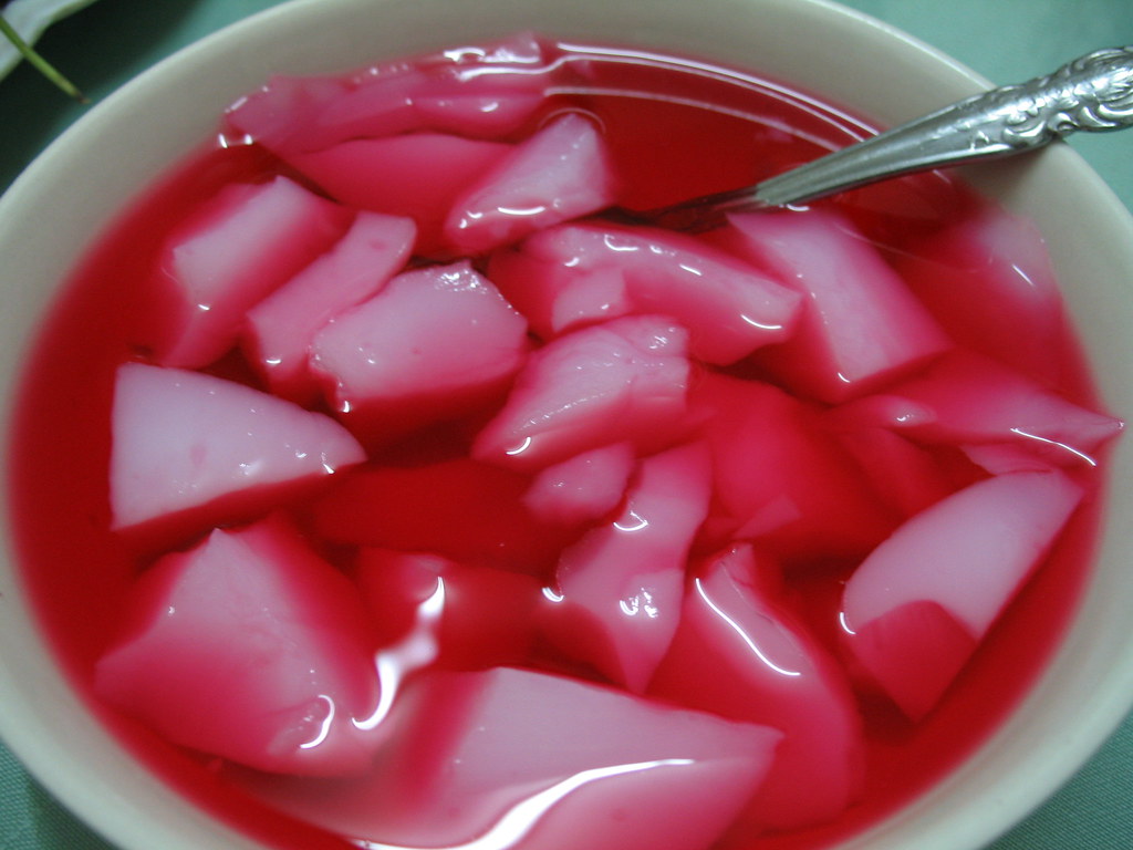 Cypriot mahalepi milk pudding topped with rose syrup and crushed pistachios