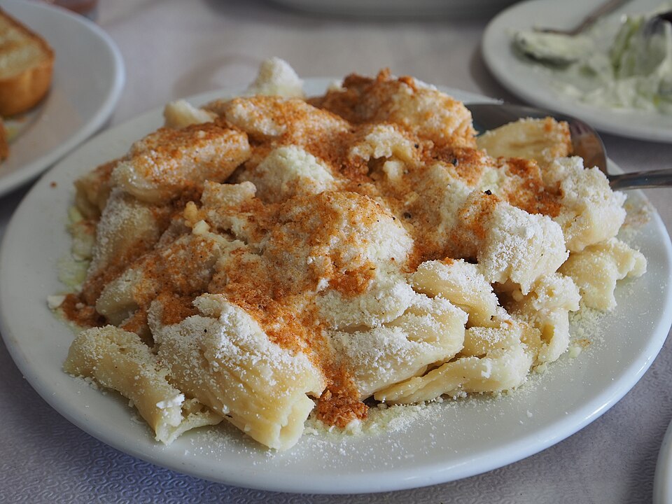 A plate of Greek makaronia me mizithra pasta with fresh cheese