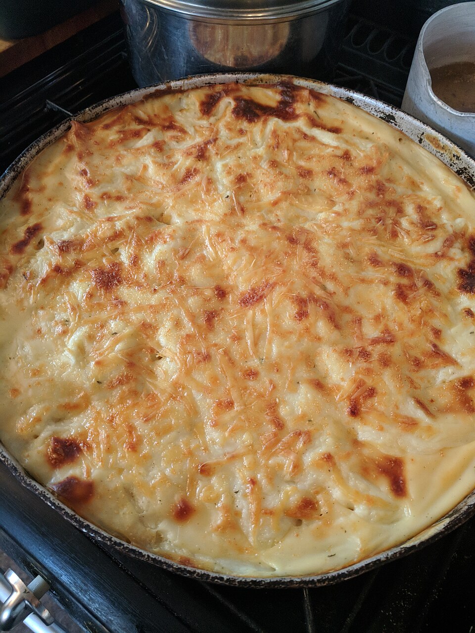 A tray of Cypriot baked macaroni with a golden halloumi topping