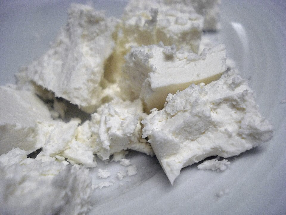 Pan-seared Greek manouri cheese drizzled with honey and sesame