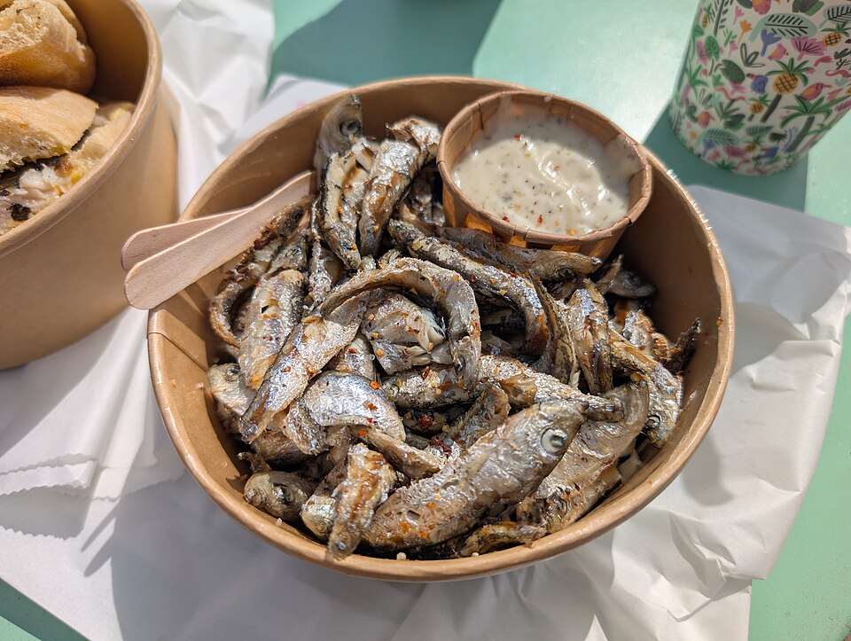 A plate of golden Greek marides tiganites fried whitebait with lemon