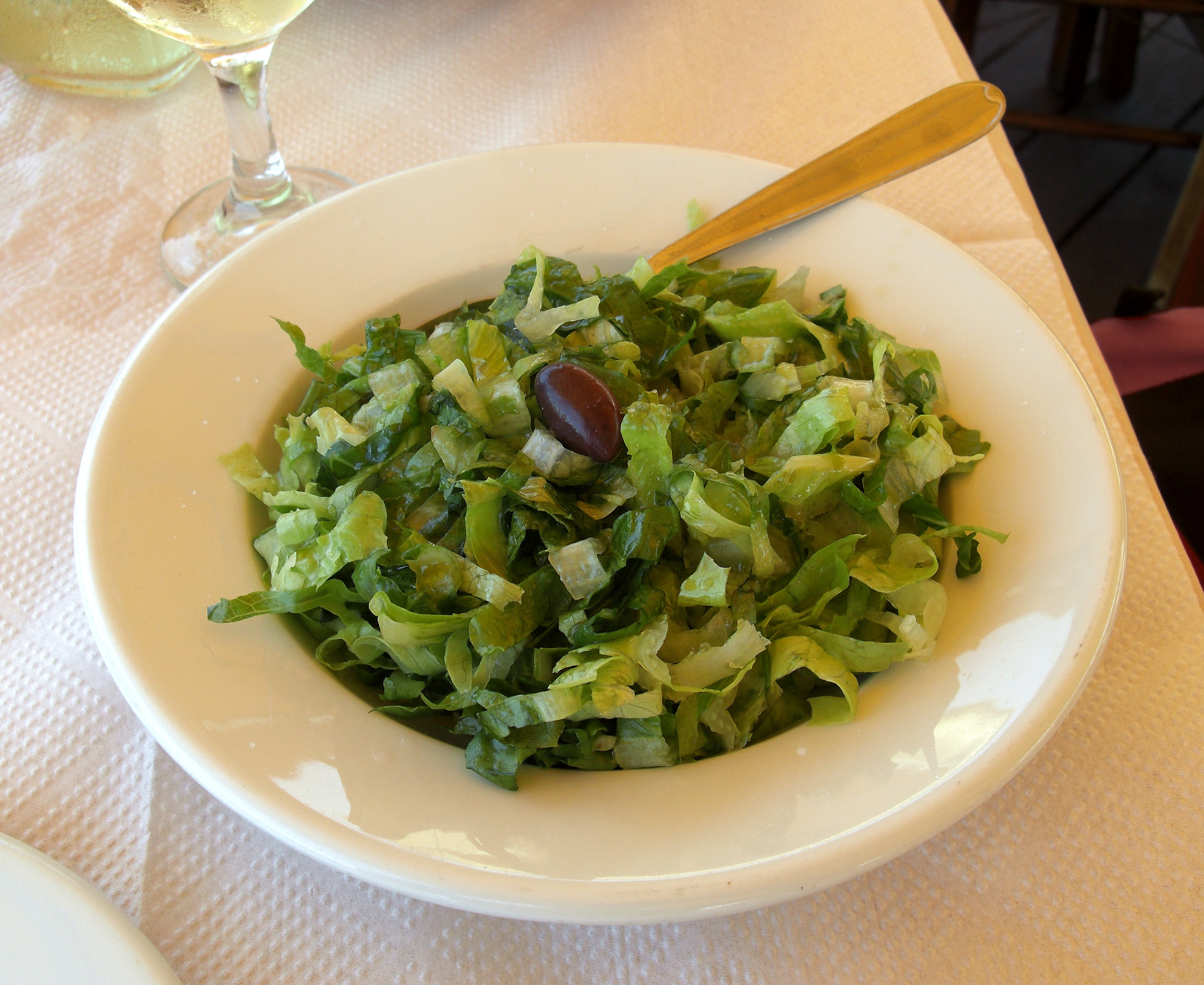 A bowl of Greek marouli salata shredded romaine lettuce salad