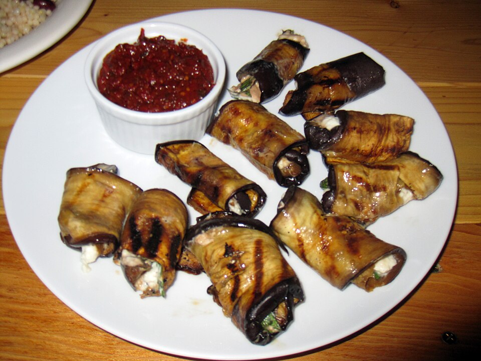 Aubergine-wrapped Greek dolmades in tomato sauce