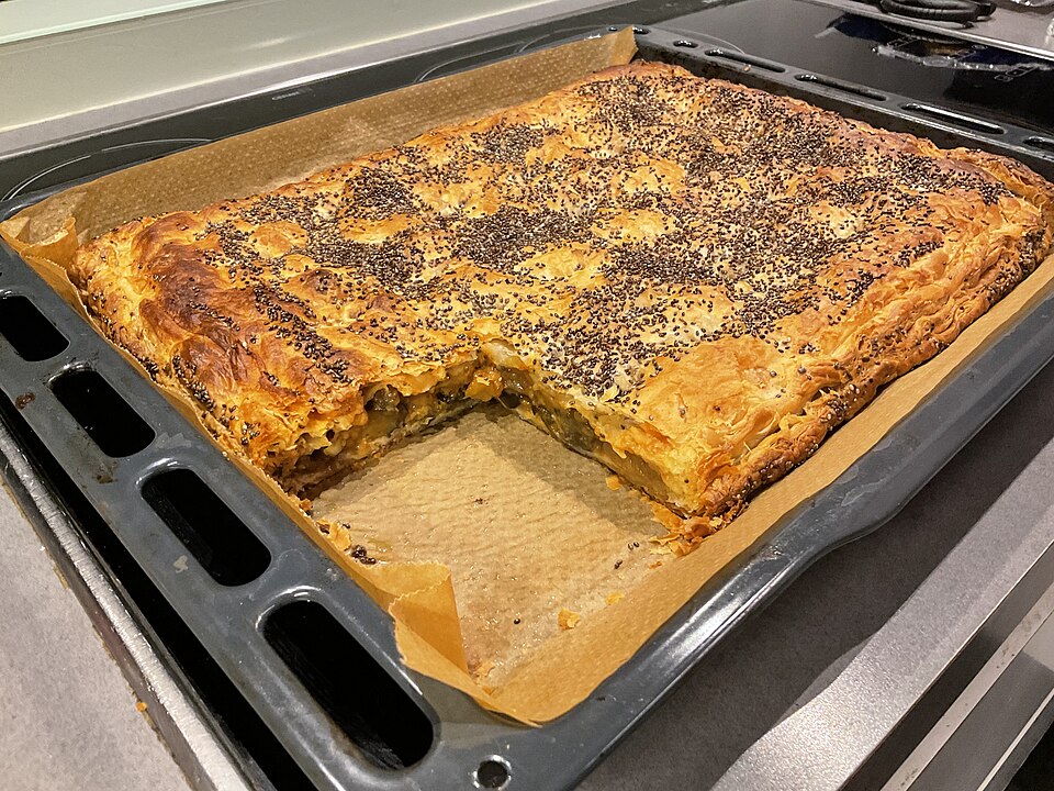 A slice of Greek melitzanopita aubergine and feta phyllo pie