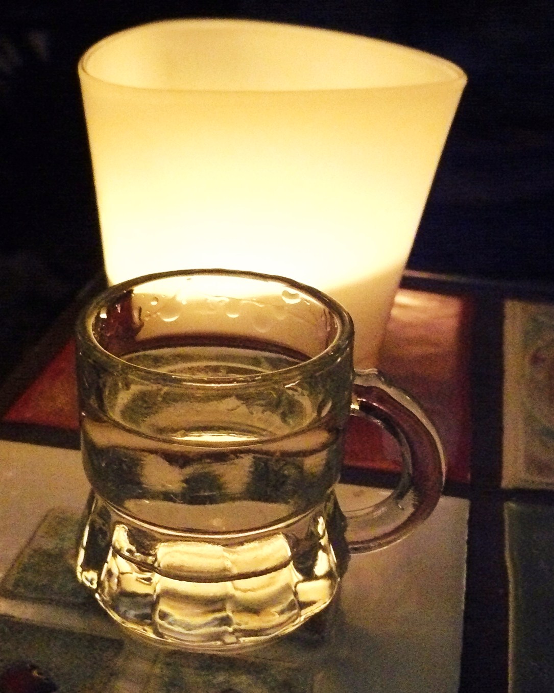 A glass of ouzo clouding as water is added