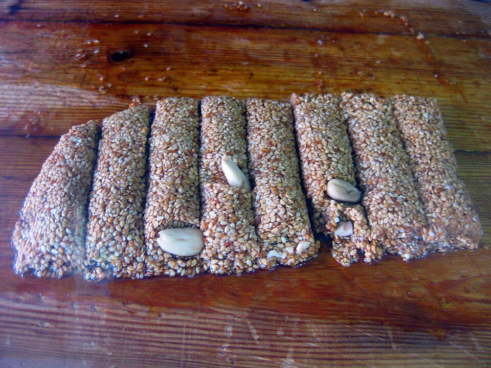 Cut bars of Greek pasteli sesame honey candy on a wooden board