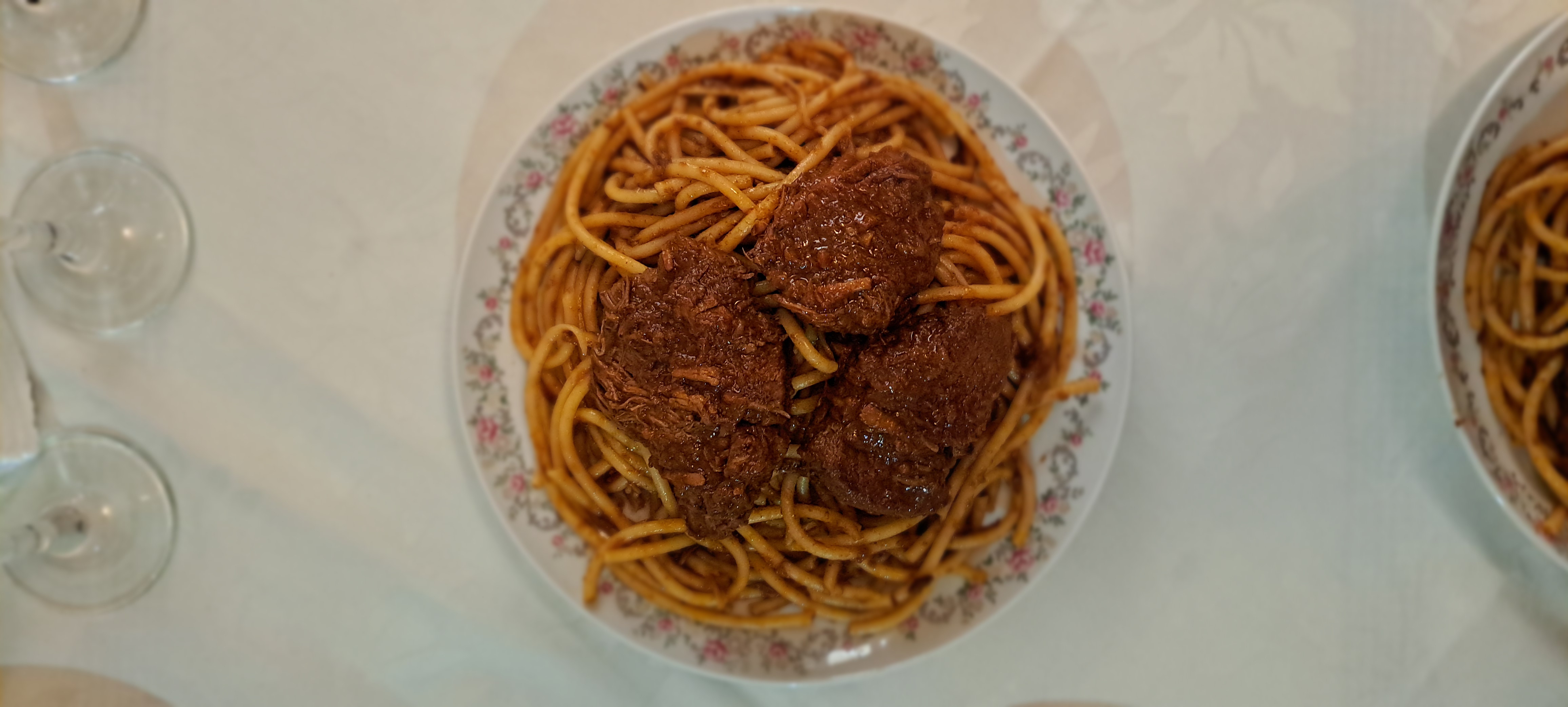 A plate of Corfu pastitsada, beef in spiced tomato sauce over pasta