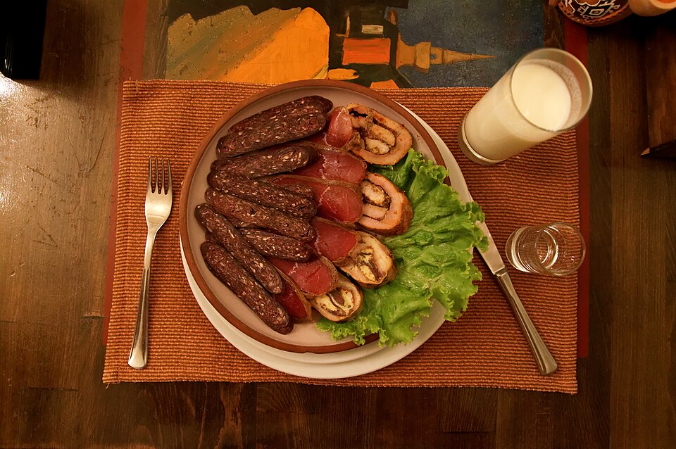 Sliced pastourma cured beef coated in red fenugreek and paprika paste