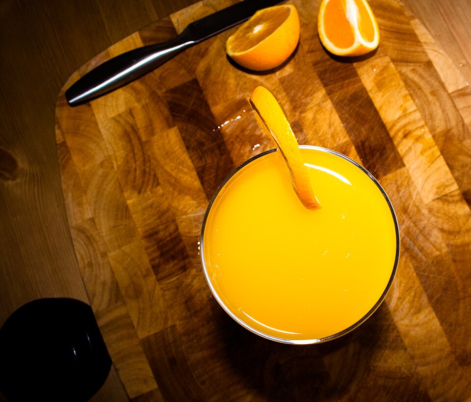 A glass of Greek portokalada fresh orange drink with ice