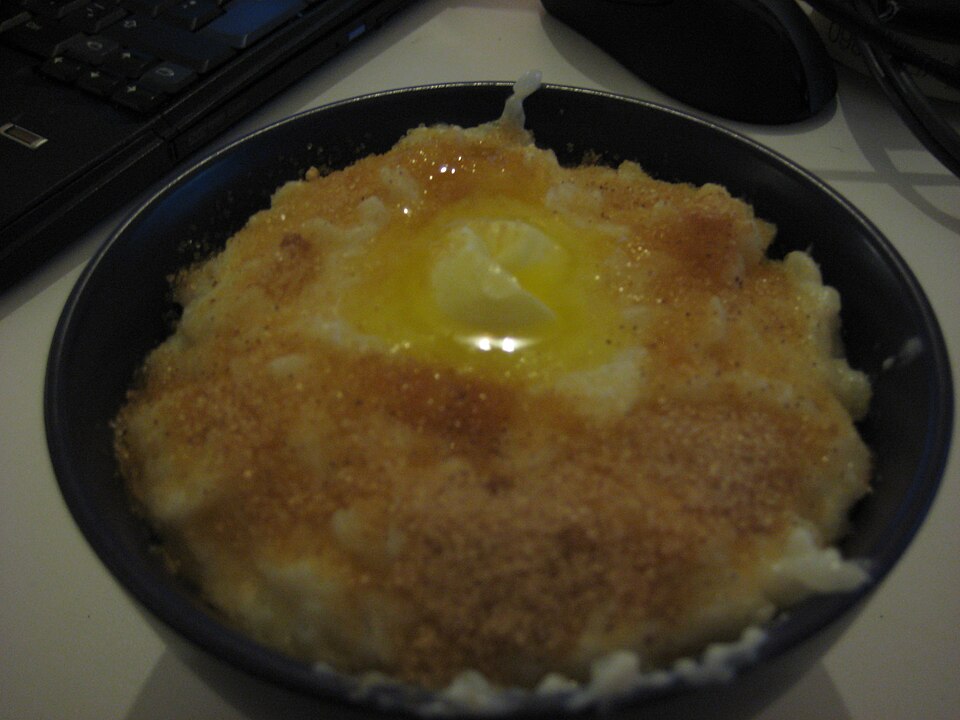 A bowl of Greek rizogalo rice pudding dusted with cinnamon
