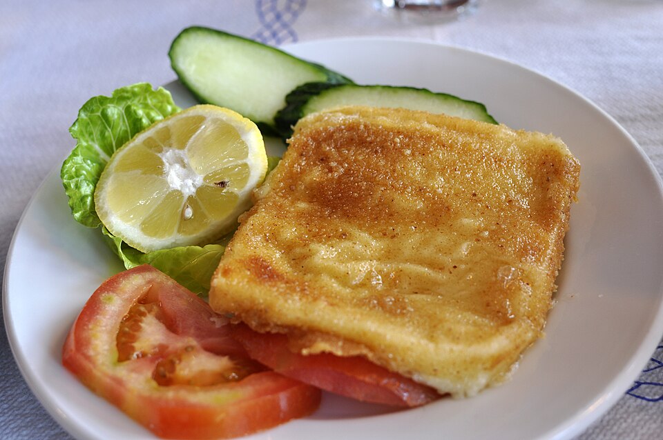 Fried Metsovone smoked cheese saganaki with lemon