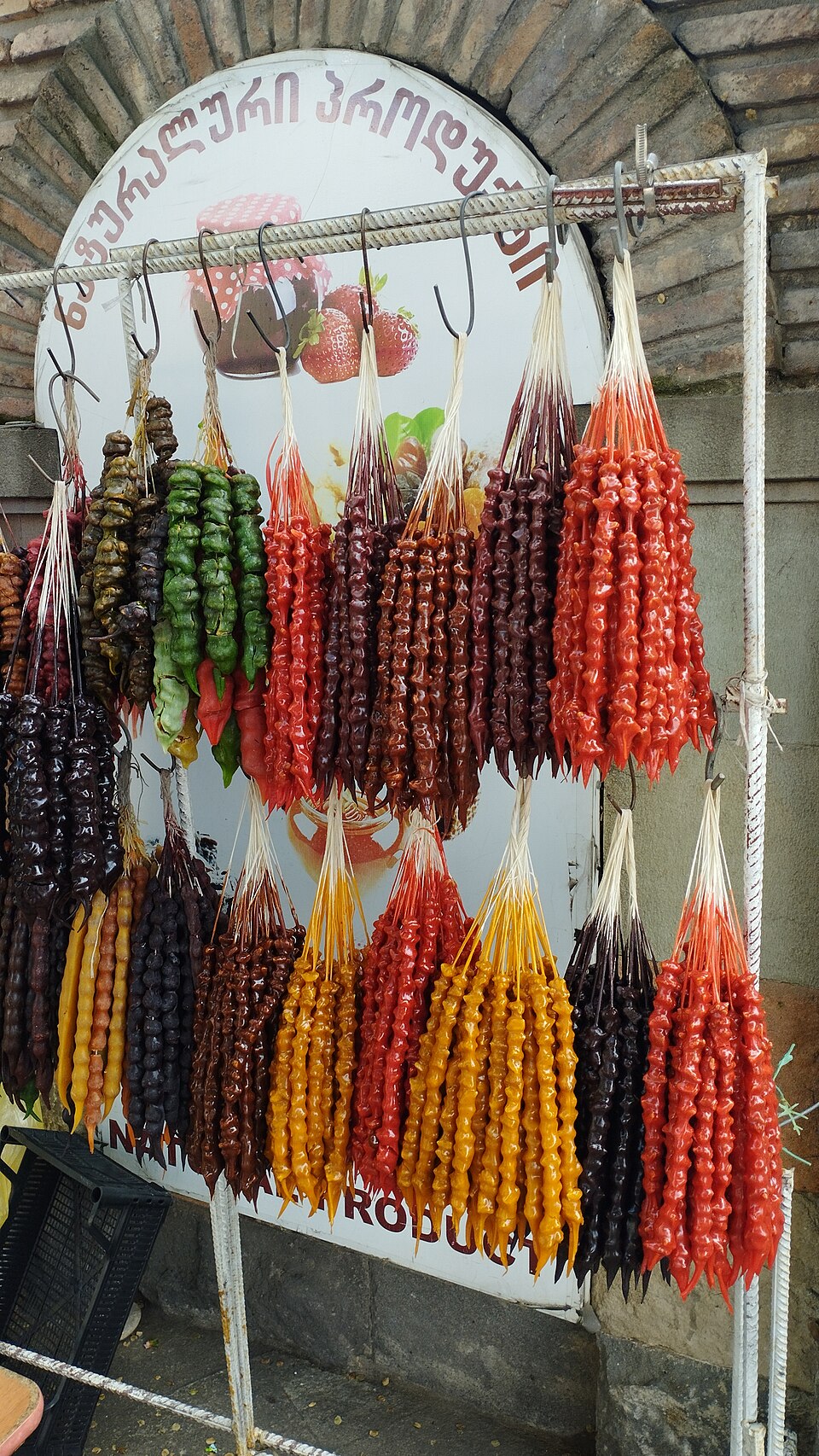Strings of Cypriot soutzoukos grape must candy hanging to set