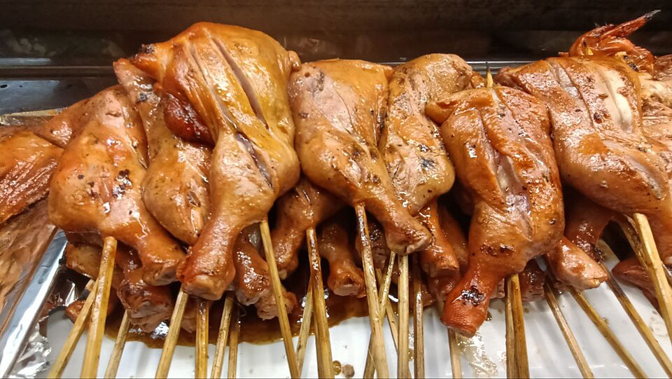 Grilled yogurt-marinated chicken souvlaki skewers with charred edges