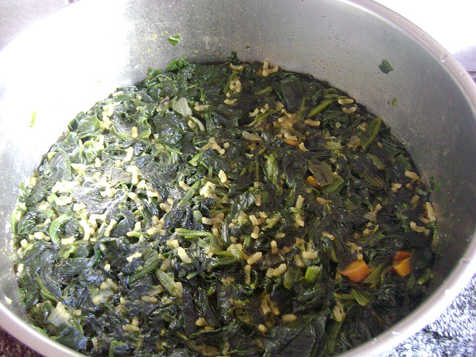 A pot of Greek spanakorizo spinach and rice, deep green and glossy