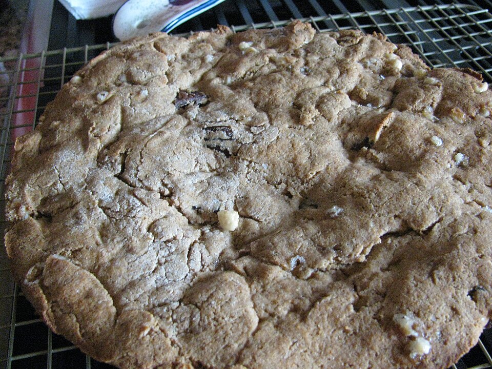 A golden spiral tahinopita bread dusted with sesame seeds