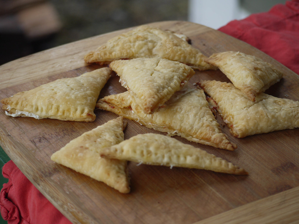 A tray of golden Greek tiropitakia trigona cheese triangle pastries