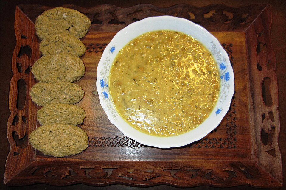 A bowl of Cypriot trahanas soup with cubes of halloumi