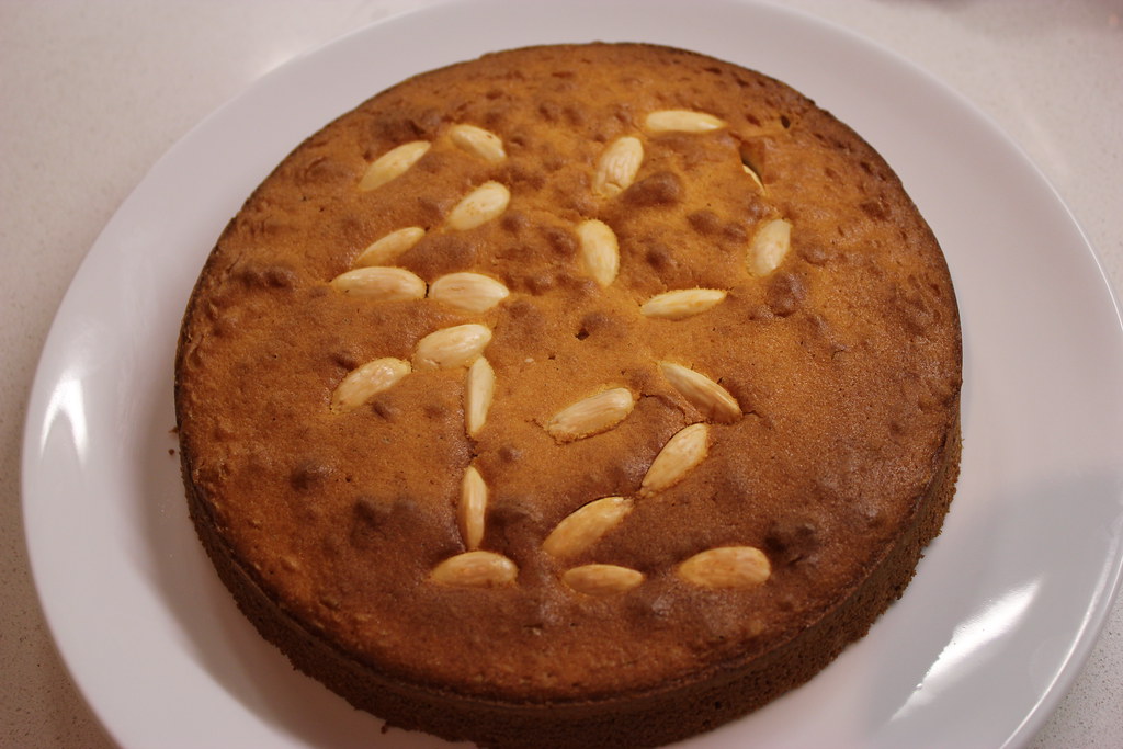 A golden Greek vasilopita New Year cake dusted with icing sugar