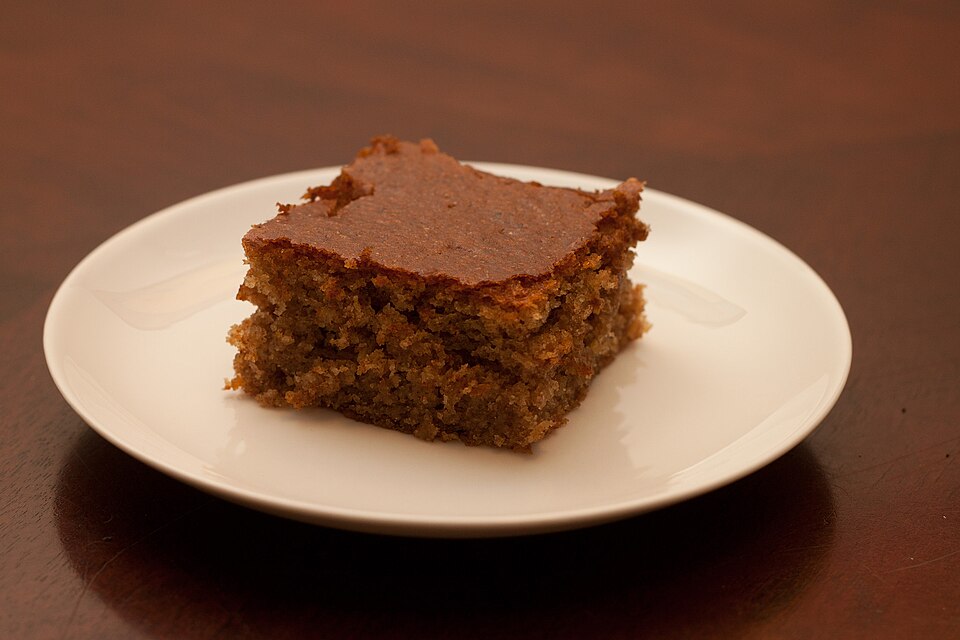 A sliced Greek yiaourtopita yogurt cake dusted with icing sugar
